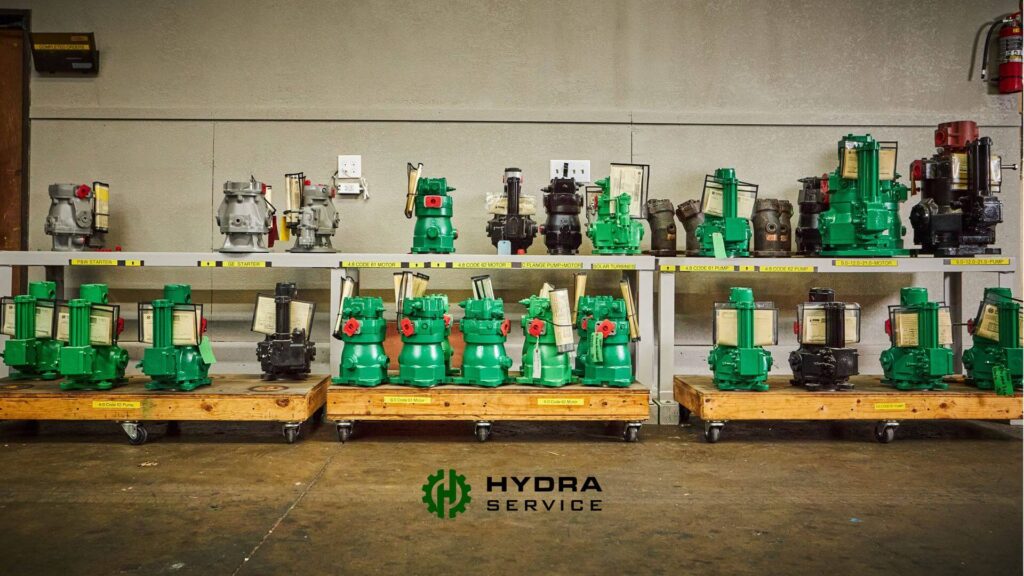 Green and black hydraulic pumps on display shelves